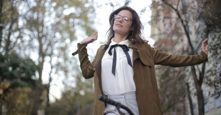 Stretches - Woman in Brown Blazer Riding a Bicycle