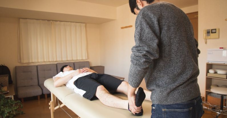 Physiotherapy - Professional massage therapist treating patient in clinic