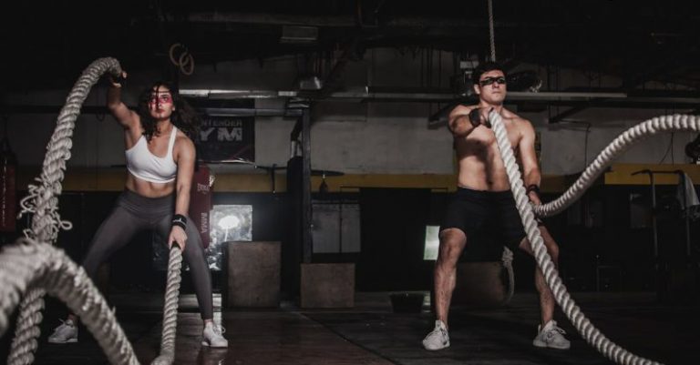 Workouts - Man And Woman Holding Battle Ropes